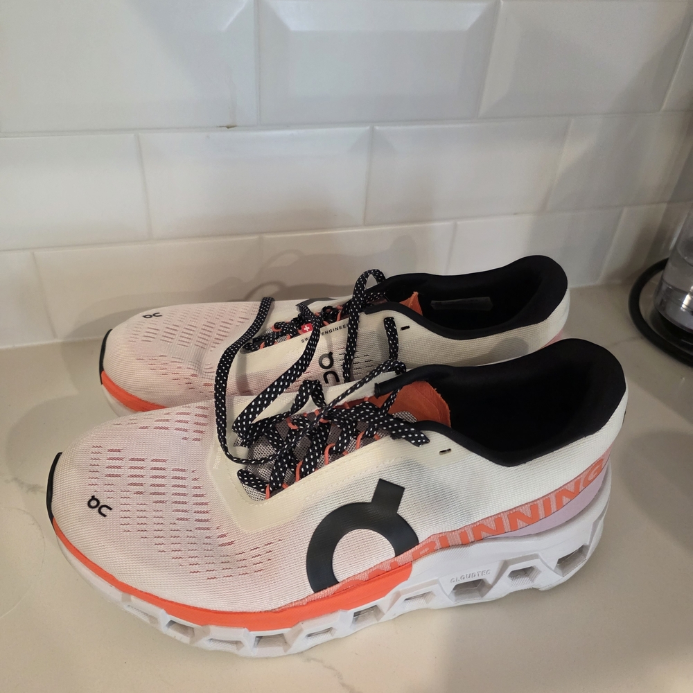 On Running White and Orange Sneakers